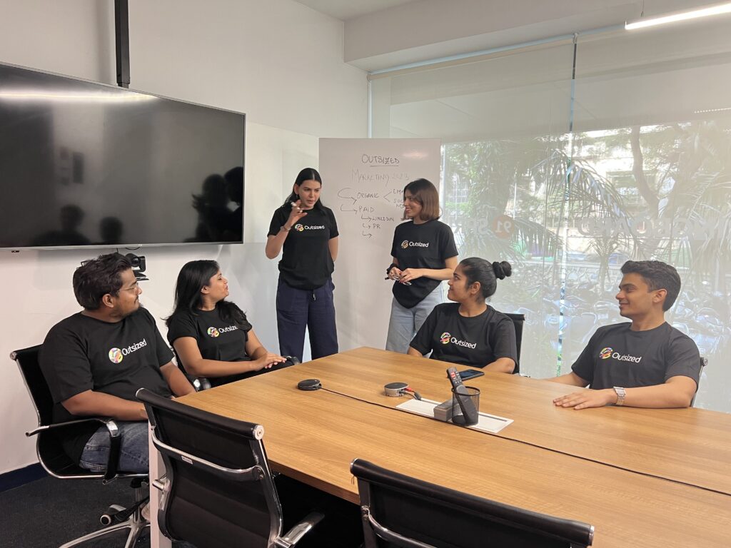 Image of multiple Outsized team members in a boardroom session