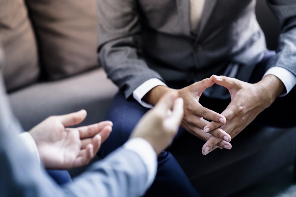 Hands of two corporate male employees in a meeting